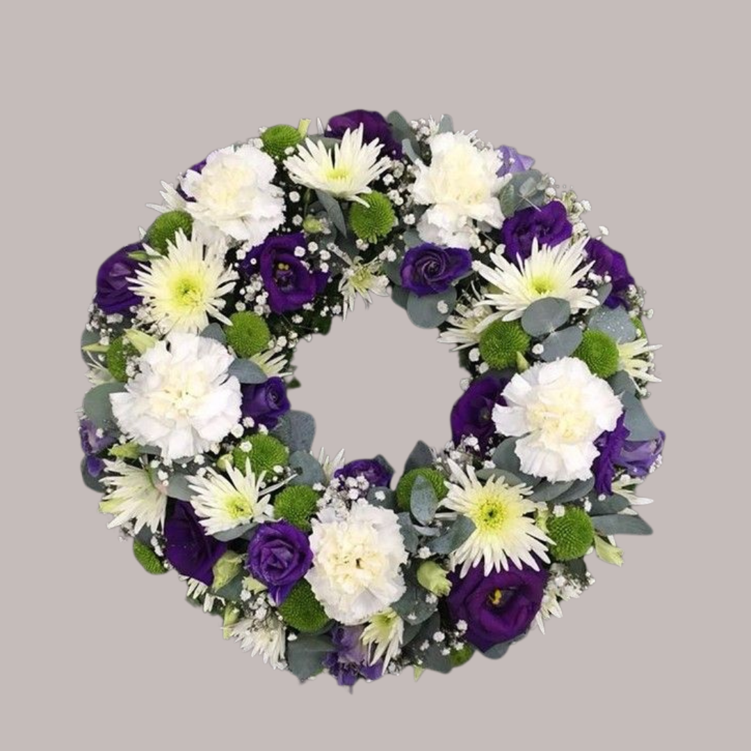 Couronne funéraire avec œillets blancs et roses violettes